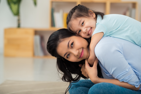 A mother and daughter holding each other.