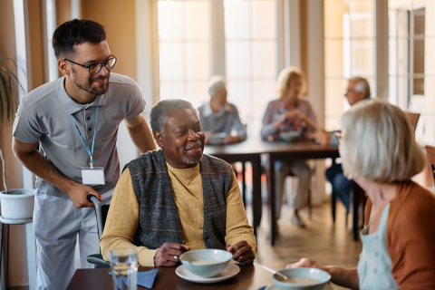 Older man with another older woman and a care worker.